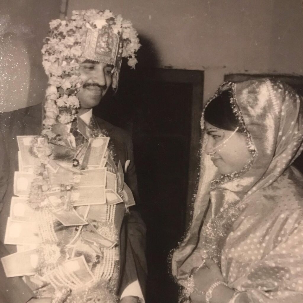 Wedding day, father in traditional garland, mother in bridal veil