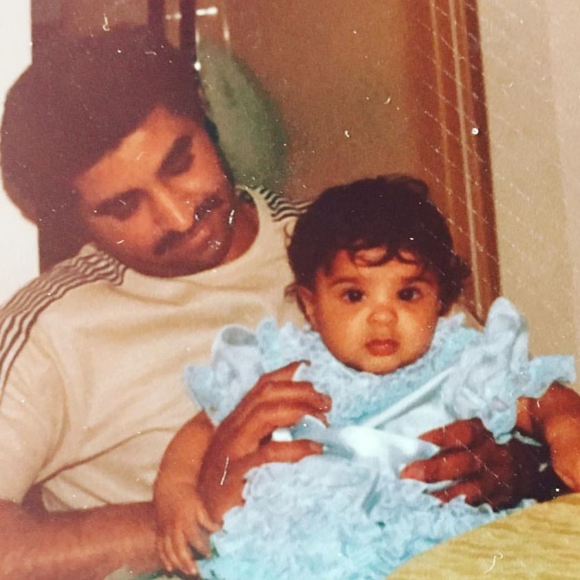 Father holding his daughter as an infant
